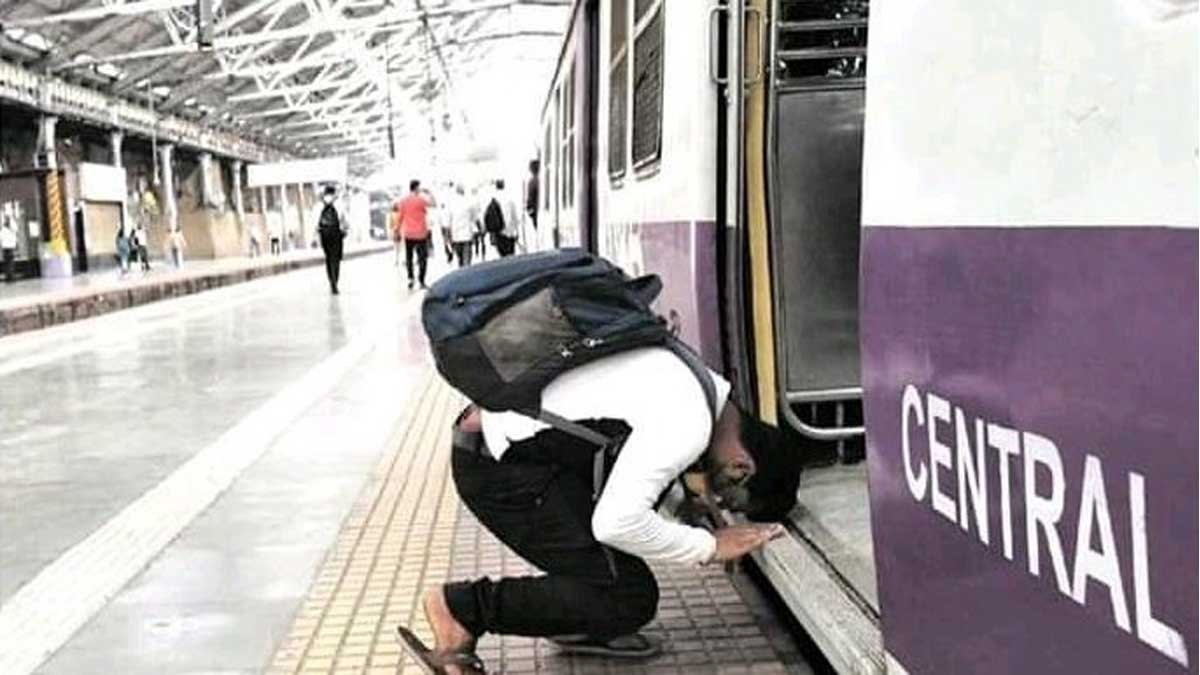man bowing in front of mumbai local